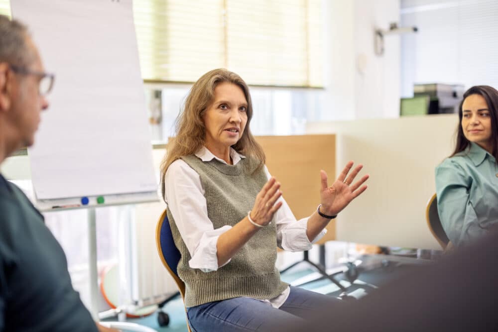 Mature woman expressing her feelings in a support group therapy session community center